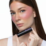 MINË Plumping Blush Stick in Pinky Promise held by model